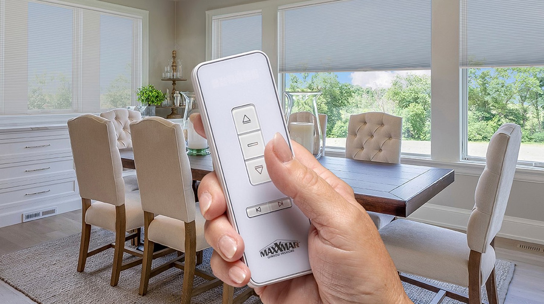 Hand holding a remote control for motorized Cellular Shades