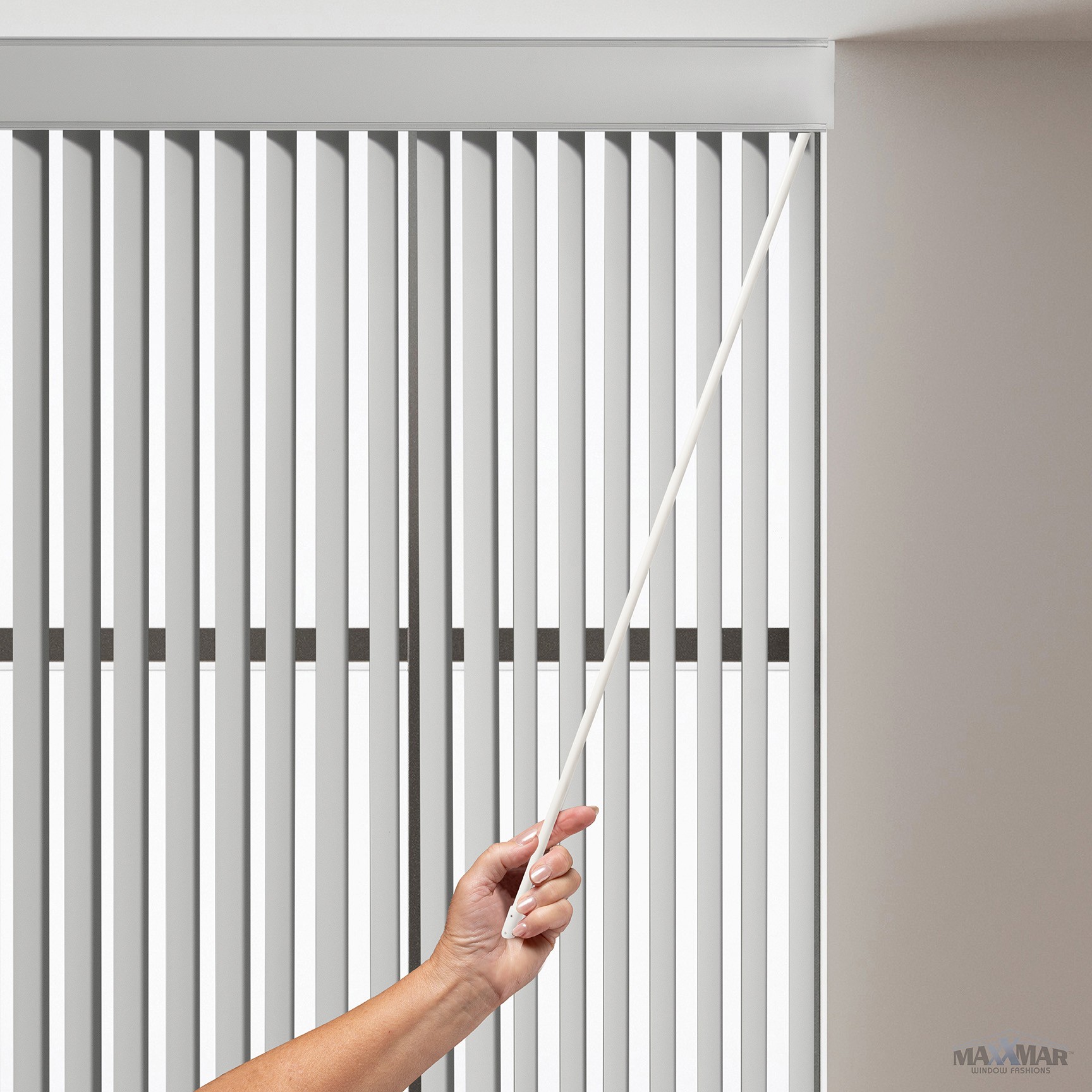 Close-up of a hand operating the PVC Verticals wand control